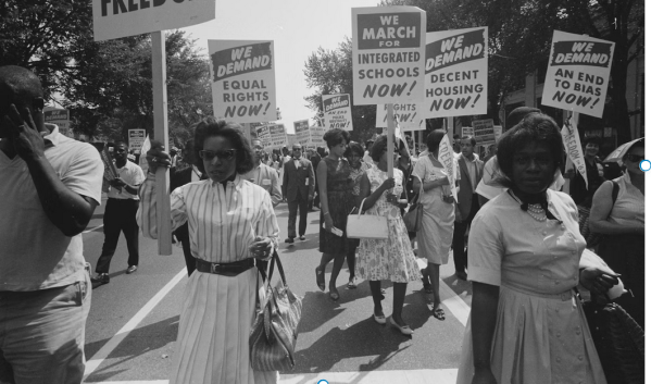Civil Rights organizers protest school segregation in a black and white photo.